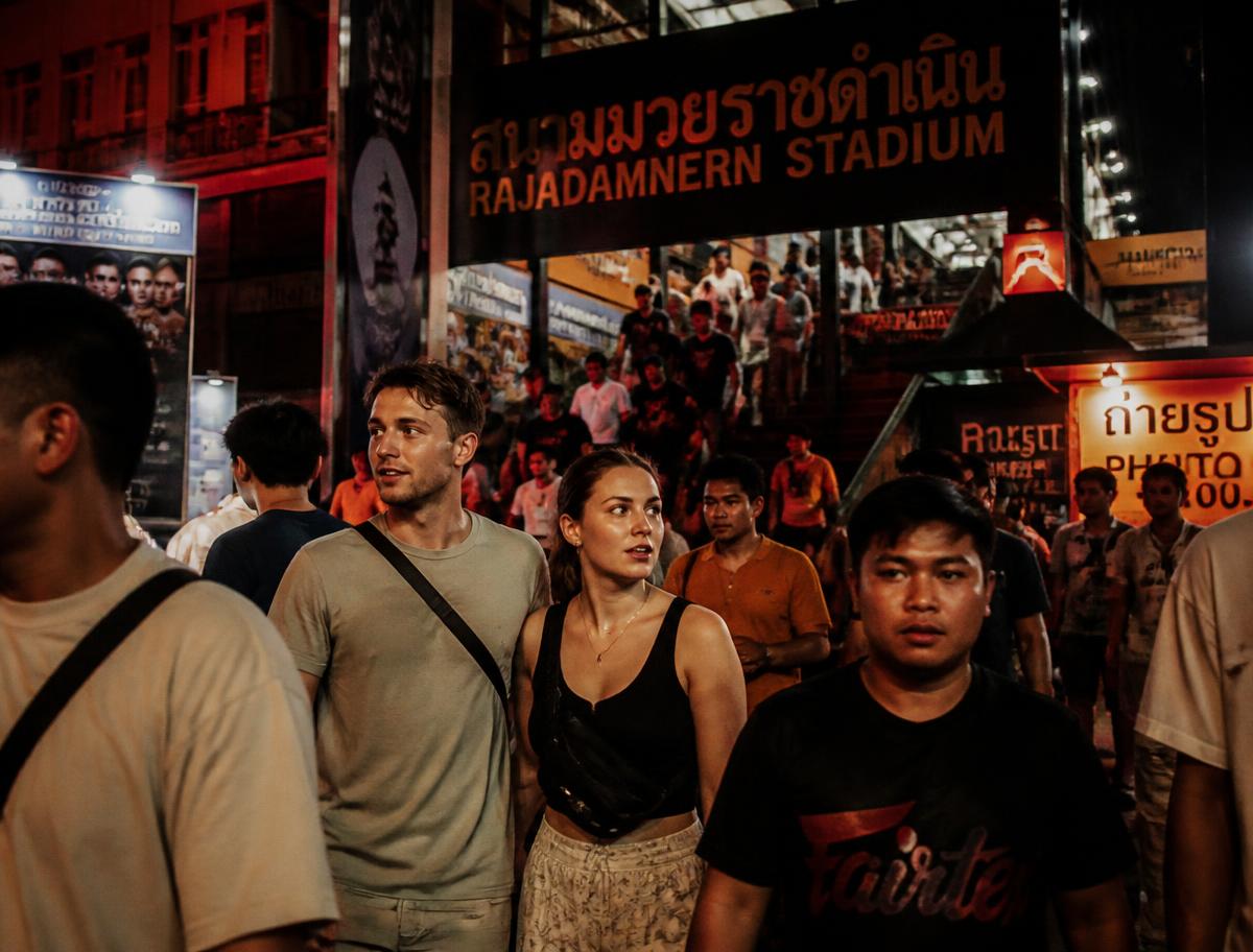 Visitors leaving Rajadamnern Stadium on a Bangkok evening